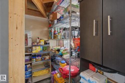 Dedicated pantry space featuring wire shelving and built-in cabinetry with brushed nickel pulls - 