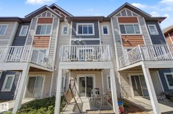 Multi-level townhome featuring a private balcony and ground-level patio - 