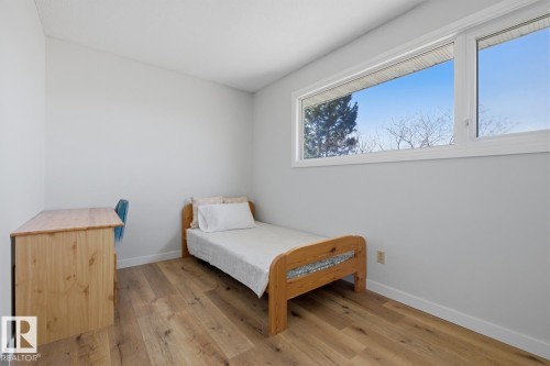 Bright room featuring wood-finish flooring and a large horizontal window - 17604 85 Avenue, Edmonton, AB - Indoor Photo Showing Bedroom