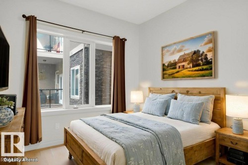 Bedroom featuring large windows and vinyl plank flooring. This room has been virtually staged. - 223 10121 80 Avenue, Edmonton, AB - Indoor Photo Showing Bedroom