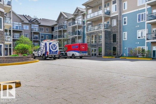 Four story building featuring balconies with glass railings. - 223 10121 80 Avenue, Edmonton, AB - Outdoor With Balcony With Facade