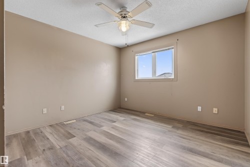 Spacious room featuring wood-finish flooring and neutral wall tones - 3917 52 Avenue, Cold Lake, AB - Indoor Photo Showing Other Room