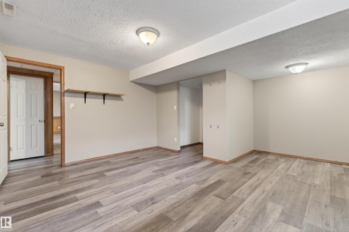 Expansive room featuring wood-finish flooring, neutral-toned walls, and recessed ceiling lighting - 3917 52 Avenue, Cold Lake, AB - Indoor Photo Showing Other Room