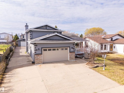 Gray exterior with white trim and a two-car garage - 3917 52 Avenue, Cold Lake, AB - Outdoor With Facade