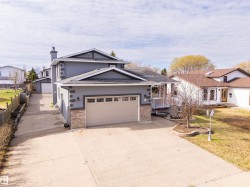Gray exterior with white trim and a two-car garage - 