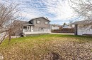 Expansive backyard featuring a multi-level deck with white railing, a separate detached garage, and perimeter fencing - 3917 52 Avenue, Cold Lake, AB  - Outdoor With Deck Patio Veranda 
