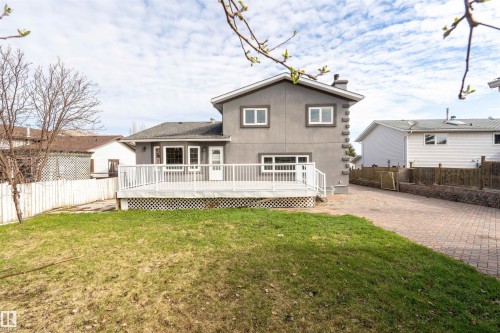 Rear exterior with a spacious wooden deck featuring white railings - 3917 52 Avenue, Cold Lake, AB - Outdoor With Deck Patio Veranda