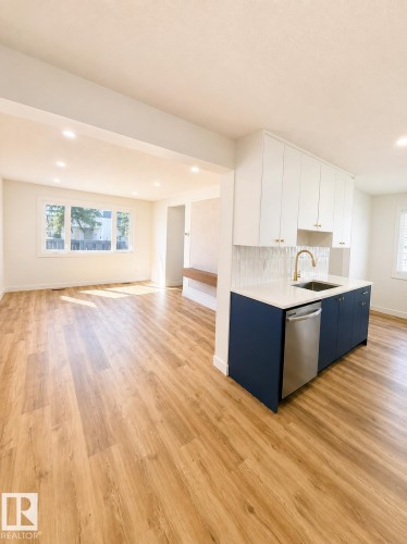 Open-concept living space featuring wood-finish flooring throughout - 224 Callingwood Two Two, Edmonton, AB - Indoor Photo Showing Kitchen