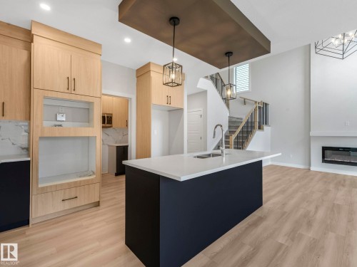 11 Dalquist Bay, Leduc, AB - Indoor Photo Showing Kitchen With Fireplace With Double Sink