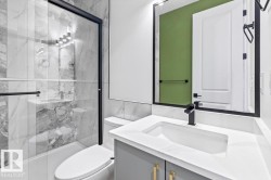 Bathroom featuring a white vanity with a rectangular integrated sink and a matte black single-handle faucet - 