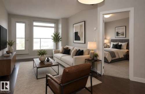 Living area featuring dark wood-finish flooring, light-toned walls, a glass-paneled door, and a large window - 531 5151 Windermere Boulevard, Edmonton, AB - Indoor Photo Showing Living Room