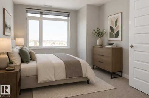Bedroom featuring a large window, light gray carpeting, and light gray walls - 531 5151 Windermere Boulevard, Edmonton, AB - Indoor Photo Showing Bedroom