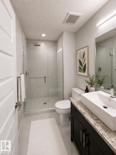 Walk-in shower with clear glass enclosure and herringbone tile flooring - 531 5151 Windermere Boulevard, Edmonton, AB - Indoor Photo Showing Bathroom