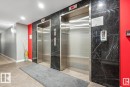 Dual stainless steel elevators featuring black marble-finish wall panels - 531 5151 Windermere Boulevard, Edmonton, AB  - Indoor Photo Showing Other Room 