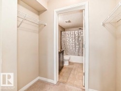 Carpeted walk-in closet featuring wire shelving and neutral-toned walls - 
