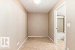 Square tile flooring extending throughout the space, complemented by neutral wall tones - 