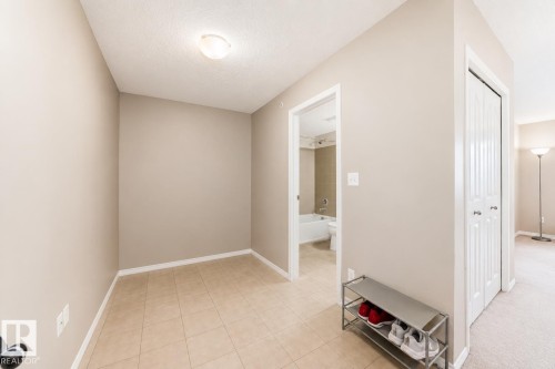 Entry area featuring ceramic tile flooring and light neutral wall paint - 404 12025 22 Avenue, Edmonton, AB - Indoor Photo Showing Other Room