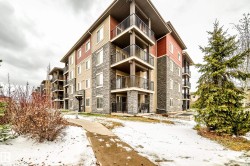 Multi-story residential building featuring a stone and siding exterior - 