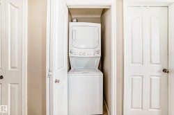 Dedicated laundry closet featuring a stackable washer and dryer unit - 