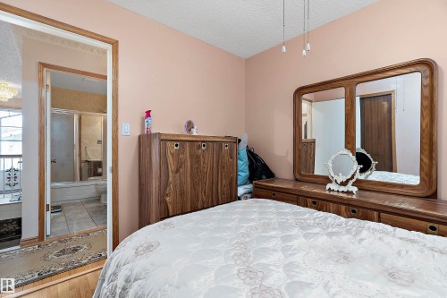 Bedroom featuring a wood-finish door frame and light wood-finish flooring - 15907 101 Street, Edmonton, AB - Indoor Photo Showing Bedroom