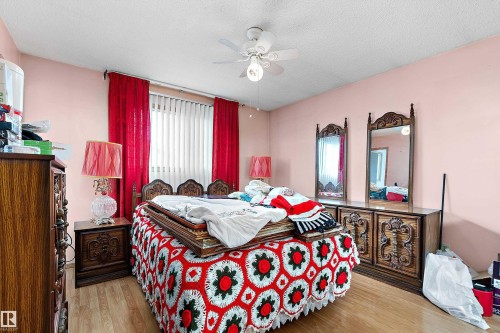 Room featuring wood-finish flooring, a ceiling fan, and painted walls - 15907 101 Street, Edmonton, AB - Indoor Photo Showing Bedroom