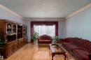 Spacious interior featuring wood-finish flooring and light-toned walls - 15907 101 Street, Edmonton, AB  - Indoor Photo Showing Living Room 