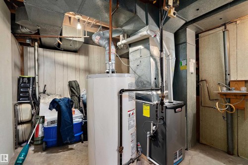 Utility room featuring a water heater, furnace, and exposed ductwork - 15907 101 Street, Edmonton, AB - Indoor Photo Showing Basement