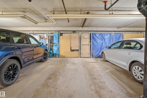 Underground parking space featuring concrete flooring and overhead utility piping - 124 10511 42 Avenue, Edmonton, AB 