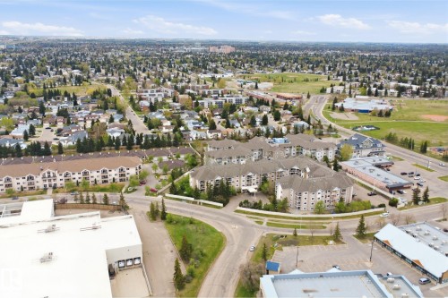 Expansive aerial view showcasing a diverse urban landscape with residential buildings and surrounding green spaces - 124 10511 42 Avenue, Edmonton, AB 
