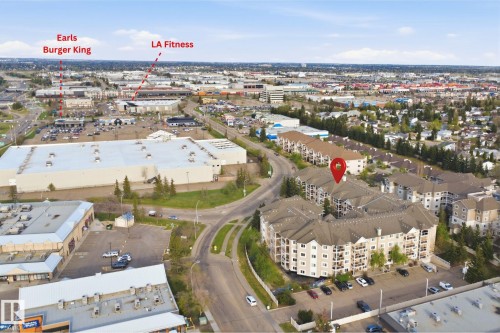 Multifamily residential building featuring multiple balconies and surface parking - 124 10511 42 Avenue, Edmonton, AB 