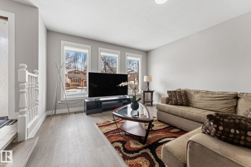 Living area featuring light wood-finish flooring, light grey painted walls, and recessed lighting - 10673 161 Avenue, Edmonton, AB - Indoor Photo Showing Living Room