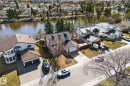 Waterfront property featuring a curved exterior, multi-pane windows, and a two-car garage - 10673 161 Avenue, Edmonton, AB  - Outdoor With Body Of Water With View 