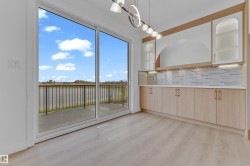 Sliding glass doors opening to a balcony with black metal railings - 