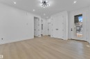 Expansive room featuring wood-finish flooring, recessed lighting, and a modern ceiling fixture - 449 Crystal Creek Link, Leduc, AB  - Indoor Photo Showing Other Room 