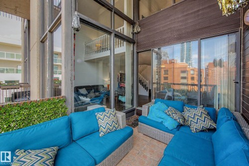 Private balcony featuring terracotta-style tile flooring and a privacy hedge - 1205 10045 118 Street, Edmonton, AB - Outdoor With Balcony With Exterior