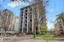 Multi-story residential building featuring a stone facade and floor-to-ceiling windows - 1205 10045 118 Street, Edmonton, AB  - Outdoor With Facade 