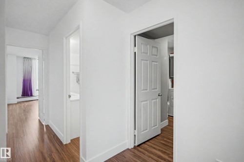 Hallway featuring wood-finish flooring, white walls, and white trim - 1205 10045 118 Street, Edmonton, AB - Indoor Photo Showing Other Room