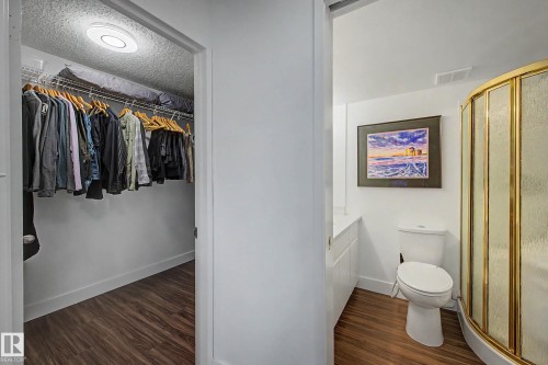 Integrated closet and bathroom featuring wood-finish flooring - 1205 10045 118 Street, Edmonton, AB - Indoor Photo Showing Other Room