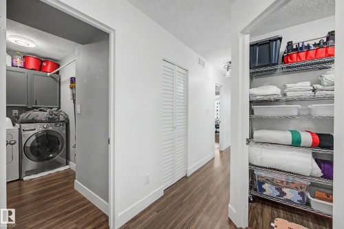 Hallway featuring wood-finish flooring, white walls, and recessed lighting - 1205 10045 118 Street, Edmonton, AB - Indoor Photo Showing Laundry Room
