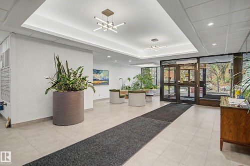 Building entrance featuring large glass doors, light-toned tile flooring, and recessed lighting - 1205 10045 118 Street, Edmonton, AB - Indoor Photo Showing Other Room