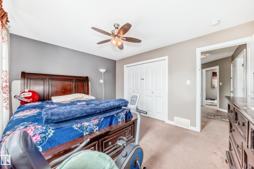 Bedroom featuring neutral tone walls and light-colored carpet flooring - 1 12833 123 Street, Edmonton, AB - Indoor Photo Showing Bedroom