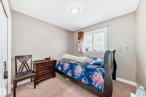 Neutral-toned walls complement the window, providing natural light to the room - 1 12833 123 Street, Edmonton, AB - Indoor Photo Showing Bedroom