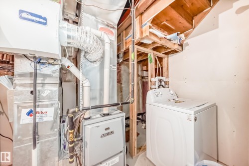 Utility area featuring furnace and water heater - 1 12833 123 Street, Edmonton, AB - Indoor Photo Showing Other Room