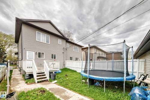 Two-story residence with light gray siding and white trim windows - 1 12833 123 Street, Edmonton, AB - Outdoor With Deck Patio Veranda