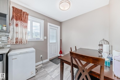 Compact dining area featuring neutral wall tones and large format tile flooring - 1 12833 123 Street, Edmonton, AB - Indoor Photo Showing Office