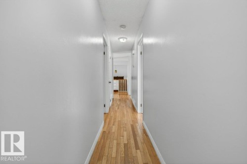 Hallway with wood-finish flooring, light gray walls, and recessed lighting - 157 Kiniski Crescent, Edmonton, AB - Indoor Photo Showing Other Room