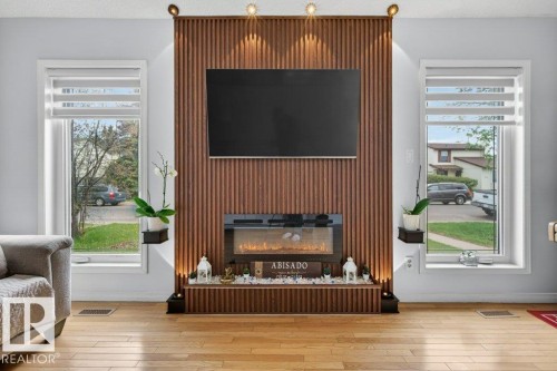 Accent wall featuring vertical wood paneling - 157 Kiniski Crescent, Edmonton, AB - Indoor Photo Showing Living Room With Fireplace