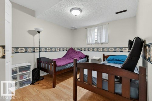 Room with wood-finish flooring, light-colored walls, and a textured ceiling - 157 Kiniski Crescent, Edmonton, AB - Indoor