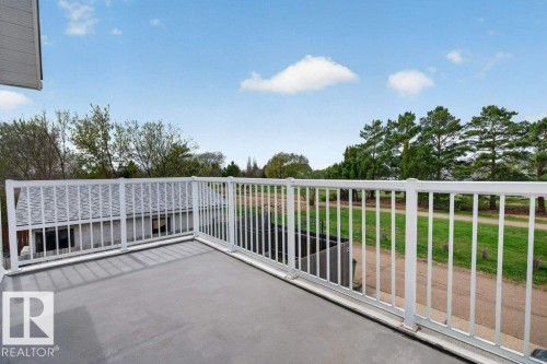 Private outdoor balcony featuring a concrete surface and white metal railing - 157 Kiniski Crescent, Edmonton, AB - Outdoor With Deck Patio Veranda