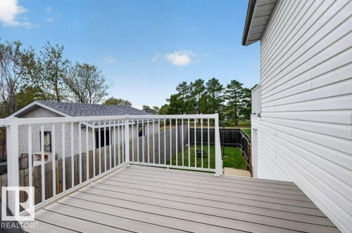 Spacious composite deck with white railings, offering outdoor living space - 157 Kiniski Crescent, Edmonton, AB - Outdoor With Exterior